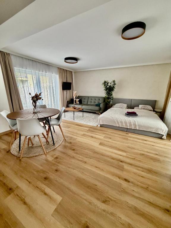 a bedroom with a bed and a table and chairs at Ateliér Smutná in Ostrava