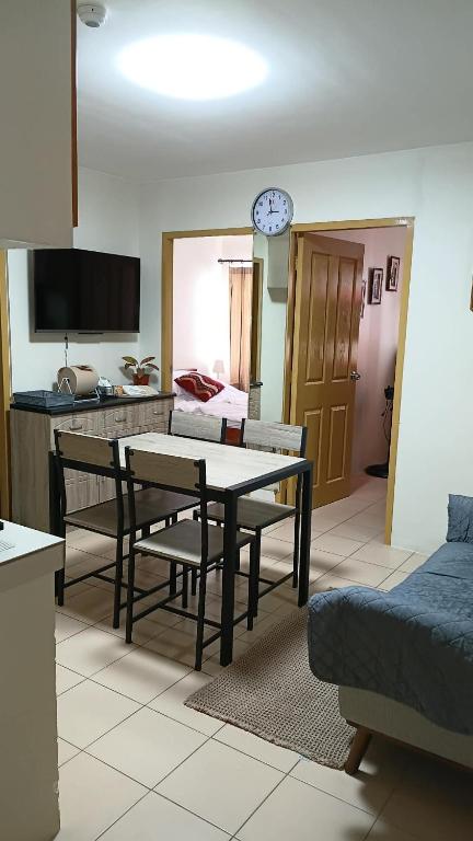 a living room with a table and a couch at Keyspace condotel in Piapi