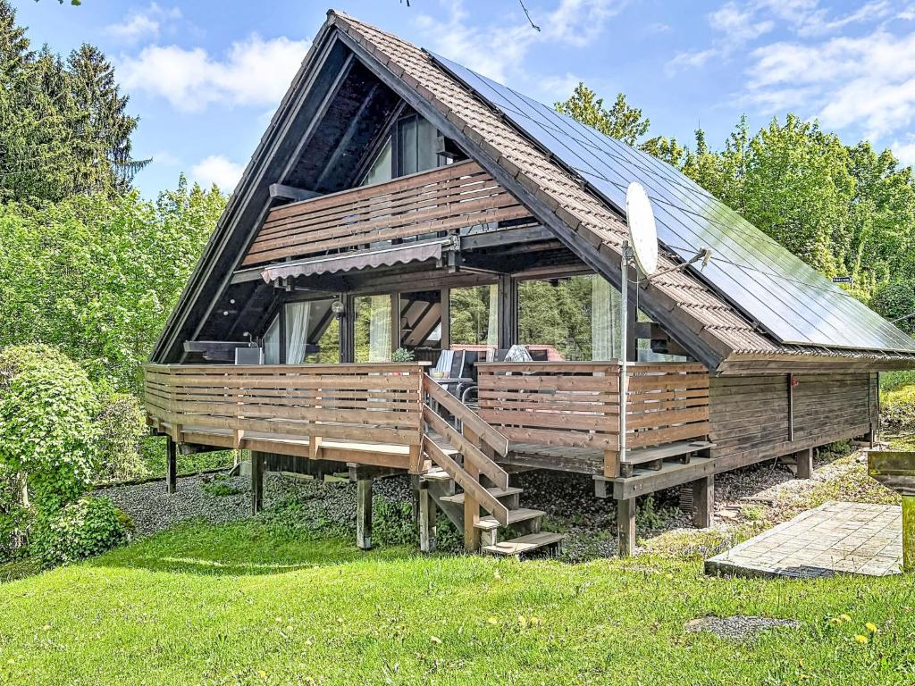 a large wooden house with a roof at Holiday Home Ferienpark Vorauf-4 by Interhome in Molberting