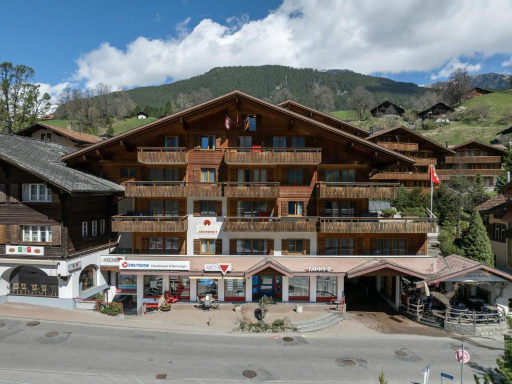 a large building in front of a mountain at Apartment Chalet Abendrot apARTments-5 by Interhome in Grindelwald