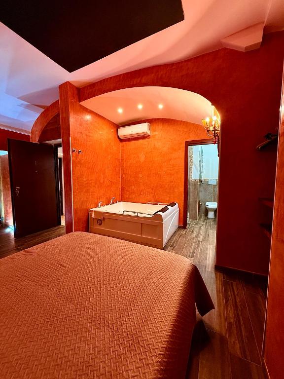 a bedroom with a large bed and a bath tub at Suites Moya 1 - SPA in Camera in Rome