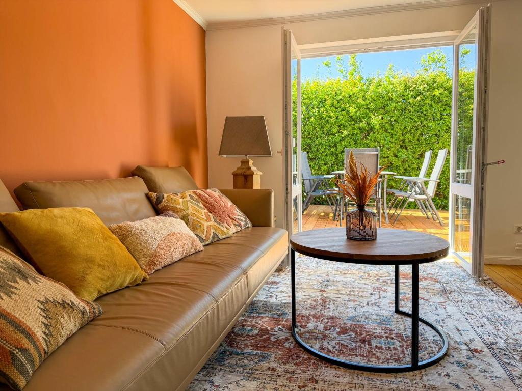 a living room with a couch and a table at Travetraum in Lübeck