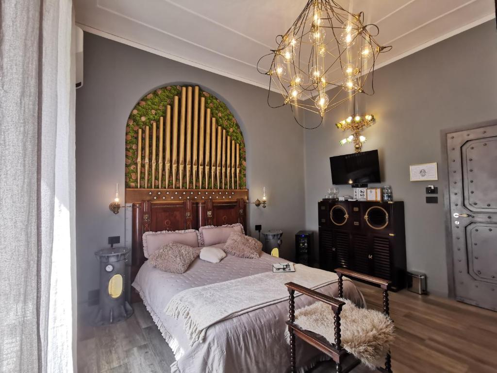 a bedroom with a large bed and a large window at The Kraken Inn - Steampunk Boutique B&B in Bergamo in Bergamo