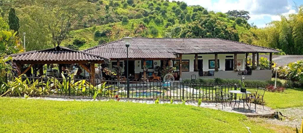 a house with a fence in front of a yard at 1920 Casa Campestre in Córdoba