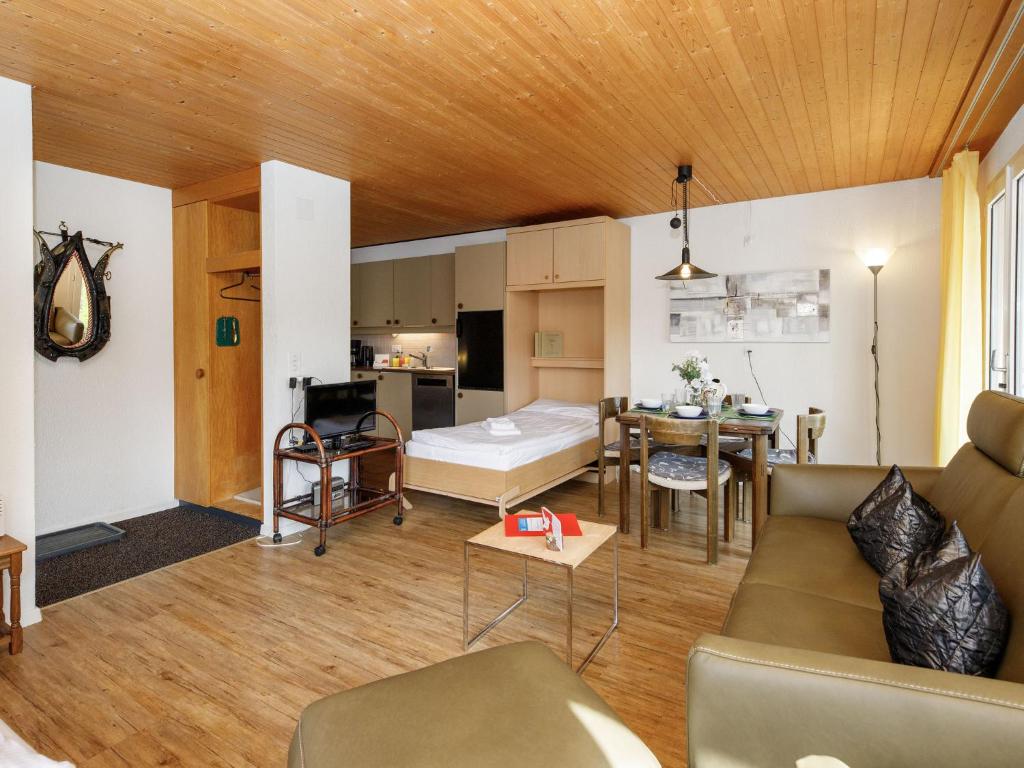 a living room with a couch and a table at Apartment Chalet Albi-2 by Interhome in Grindelwald