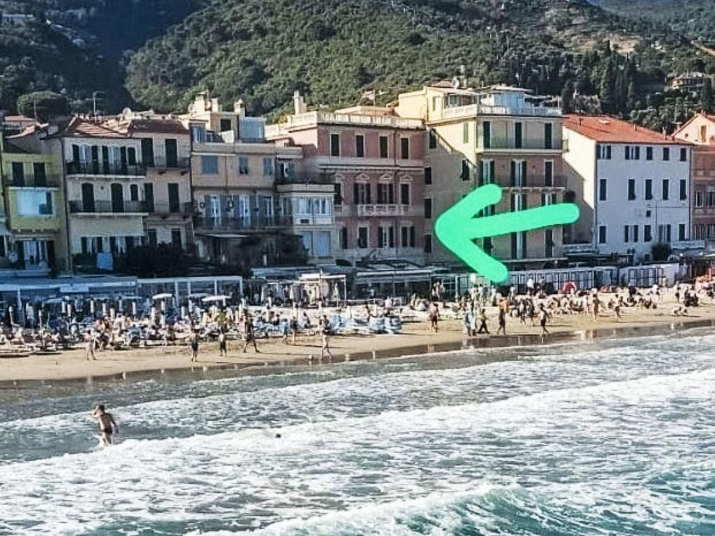 a green arrow is flying over a beach at Apartment Emanuela by Interhome in Alassio