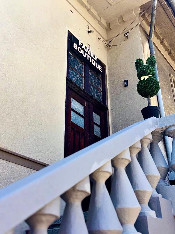 a door in a building with a plant on the stairs at Family Boutique in Veliko Tŭrnovo