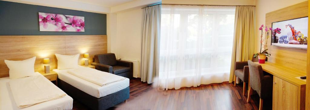 Postel nebo postele na pokoji v ubytování BlnCty Hotel