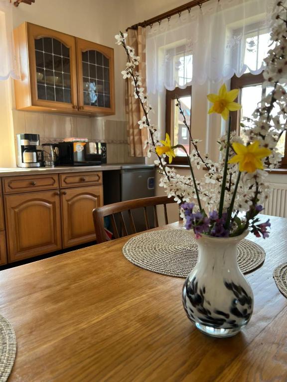 a vase filled with flowers sitting on a table at Vila Kučera in Chřibská