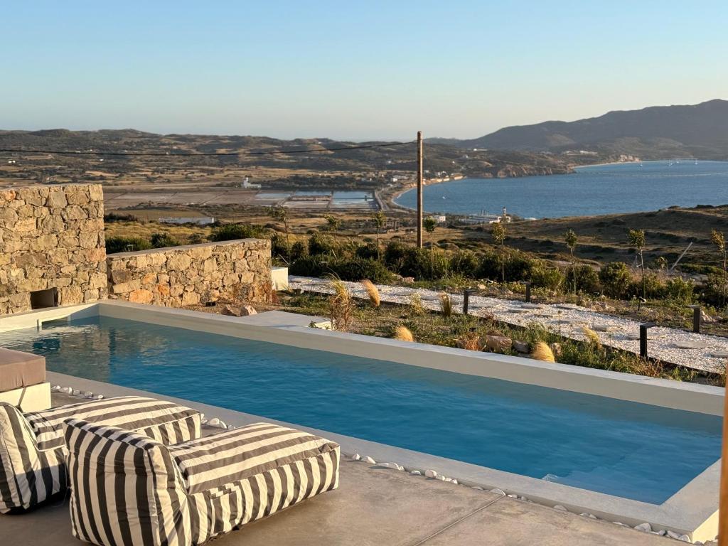 a swimming pool with a view of the ocean at Villa Nabia by Milos Concierge in Adamantas