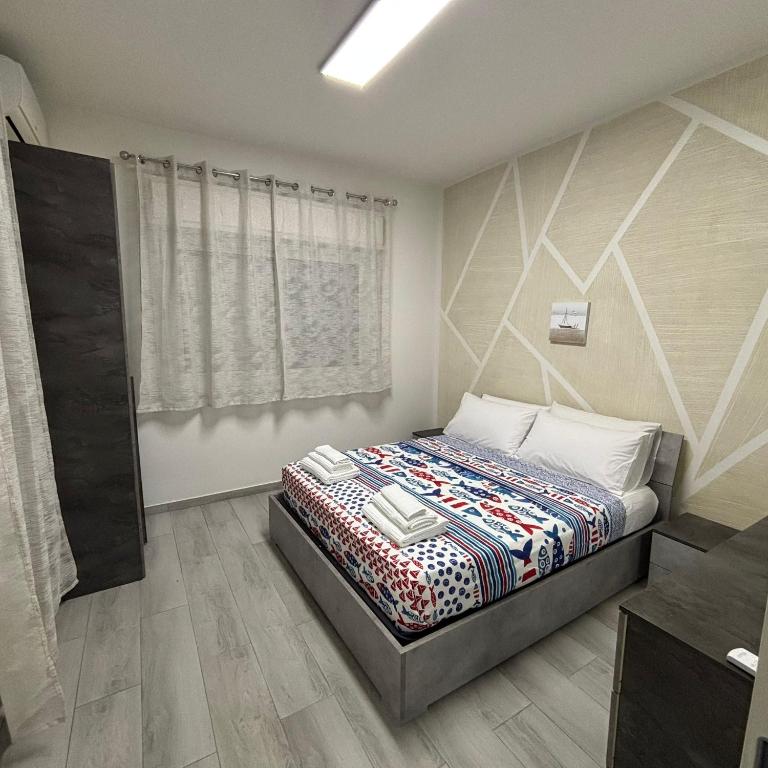 a bedroom with a bed in a room at Nido di Pace in Giardini Naxos