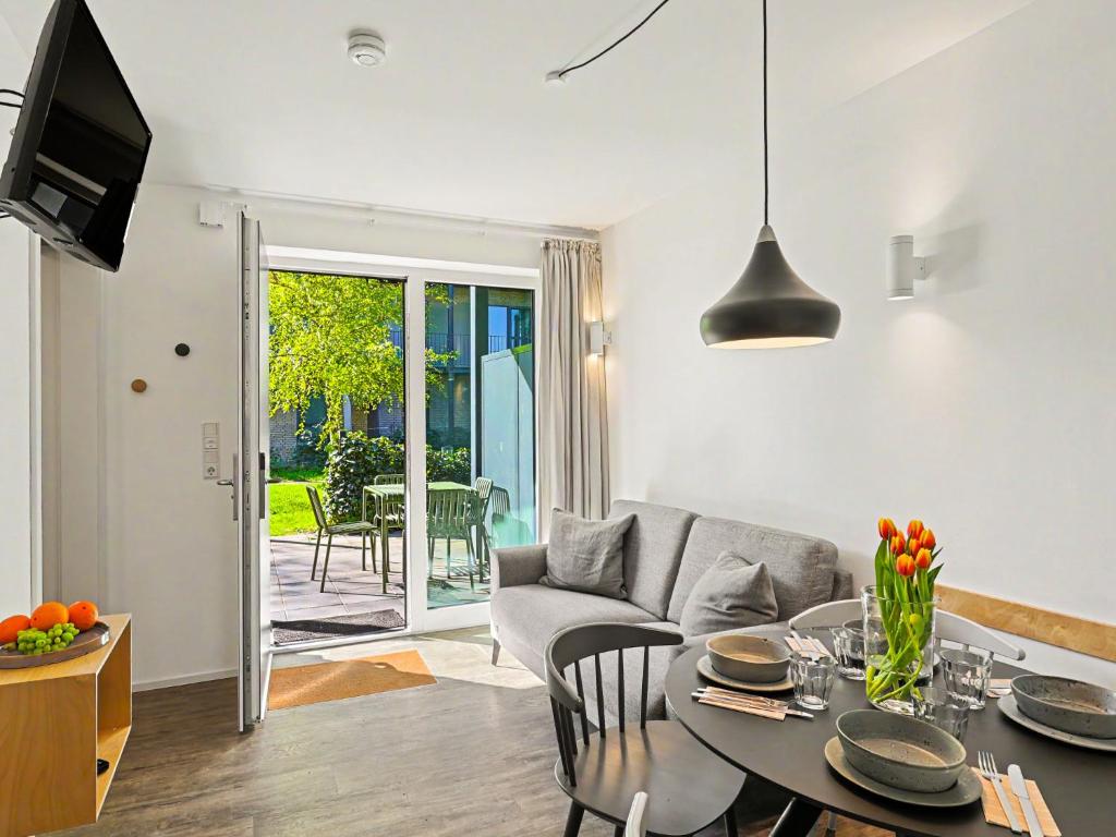 a living room with a table and a couch at Apartment Seewind by Interhome in Lembruch