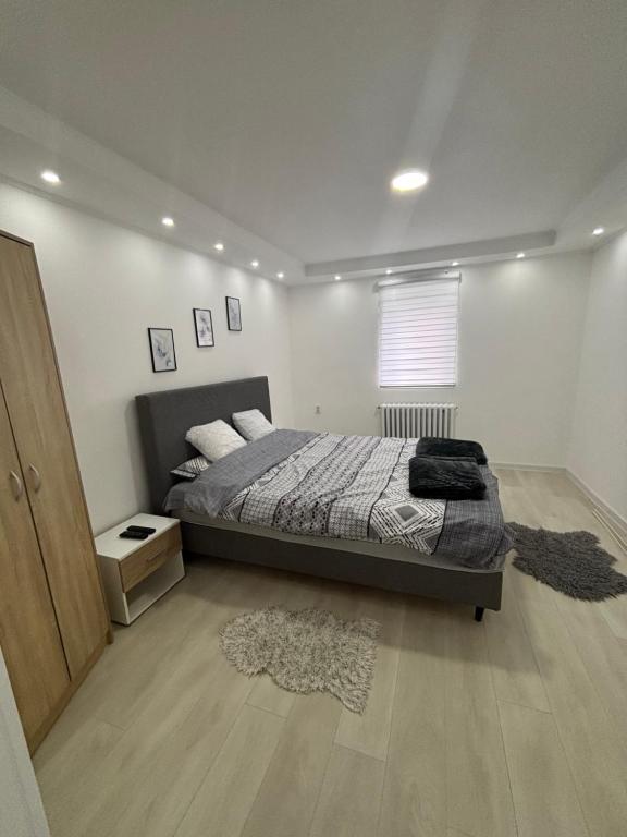 a bedroom with a bed and a window and a rug at Diamond apartment in Kikinda