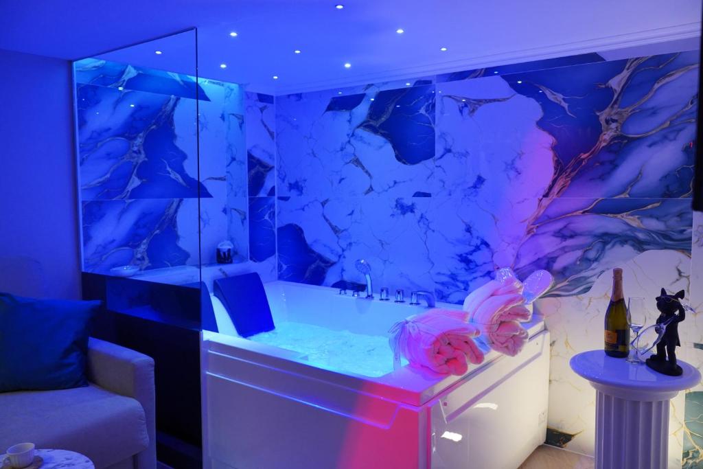 a bathroom with a bath tub with a purple at DRM Bed&Breakfast in Marcianise