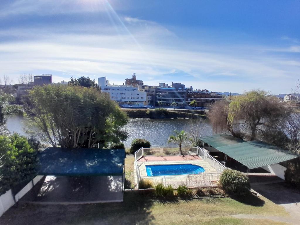 a swimming pool in the middle of a river at CRISTAL BuenaVista in Villa Carlos Paz