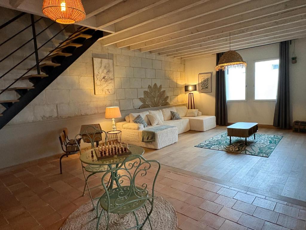 a living room with a couch and a table at L Écrin de Jade Maison de Bourg La MENITRE in La Menitré