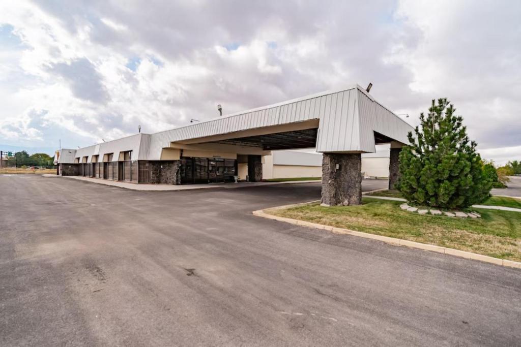 a large white building on the side of a road at Studio 6 Pocatello, ID in Pocatello