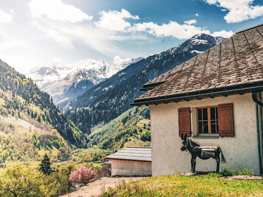 a house with a donkey statue in front of it at Apartment Casa Foppa by Interhome in Rabius