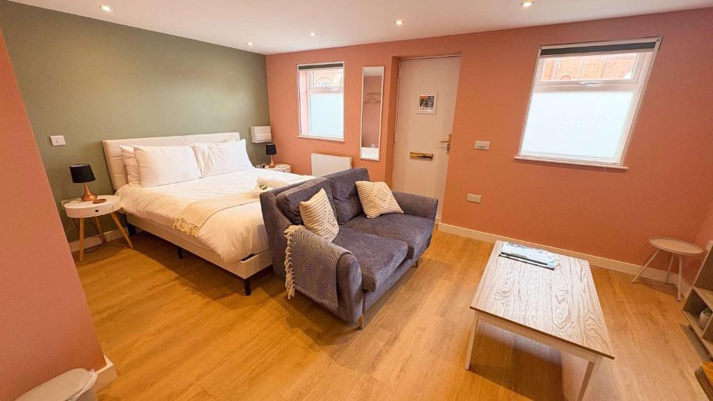a bedroom with a bed and a couch at Studio Flat in Seymour Road in Bristol