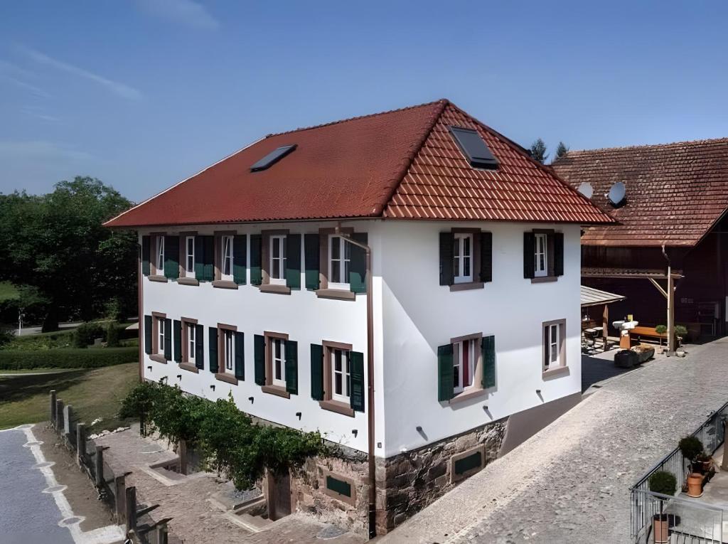 a white building with a red roof at Roserhof Gengenbach in Gengenbach