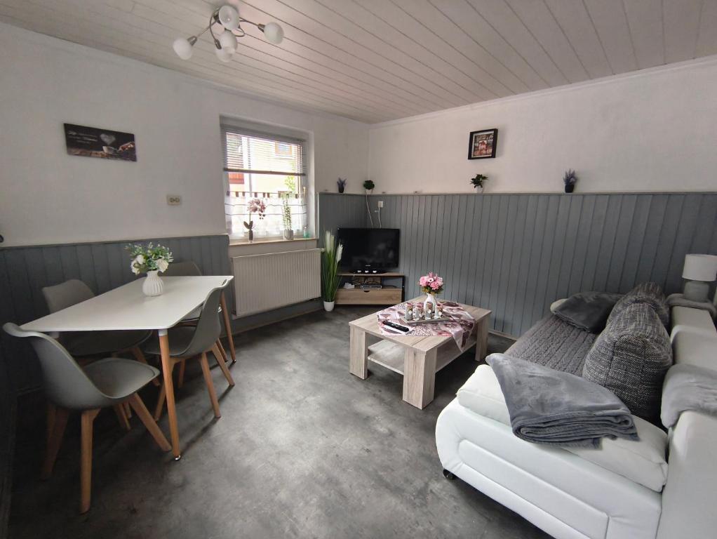 a living room with a couch and a table at FeWo Mephisto in Pottenstein