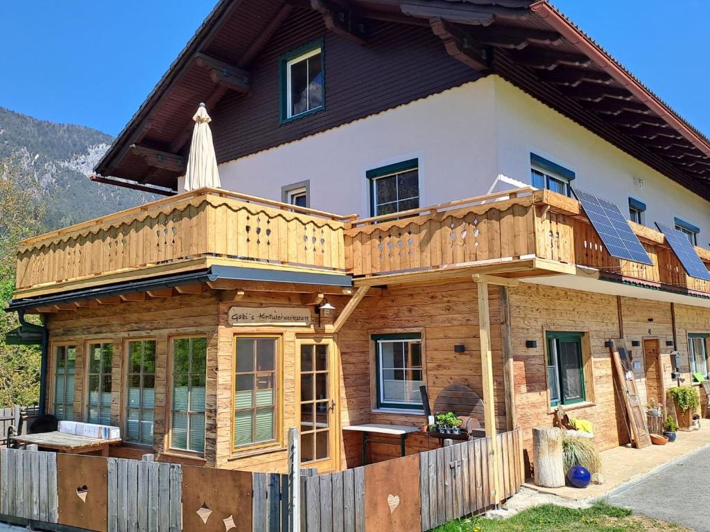 a house with a deck on the front of it at Naturidyll Brunner in Köstendorf