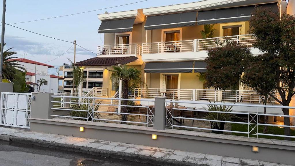 a house with a fence in front of it at MG Luxury Living in Nea Vrasna