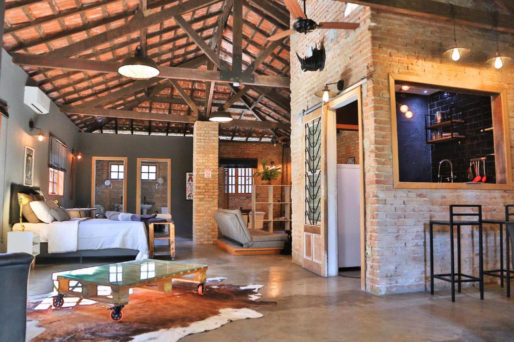 a living room with a couch and a table at Loft Industrial in Santo André