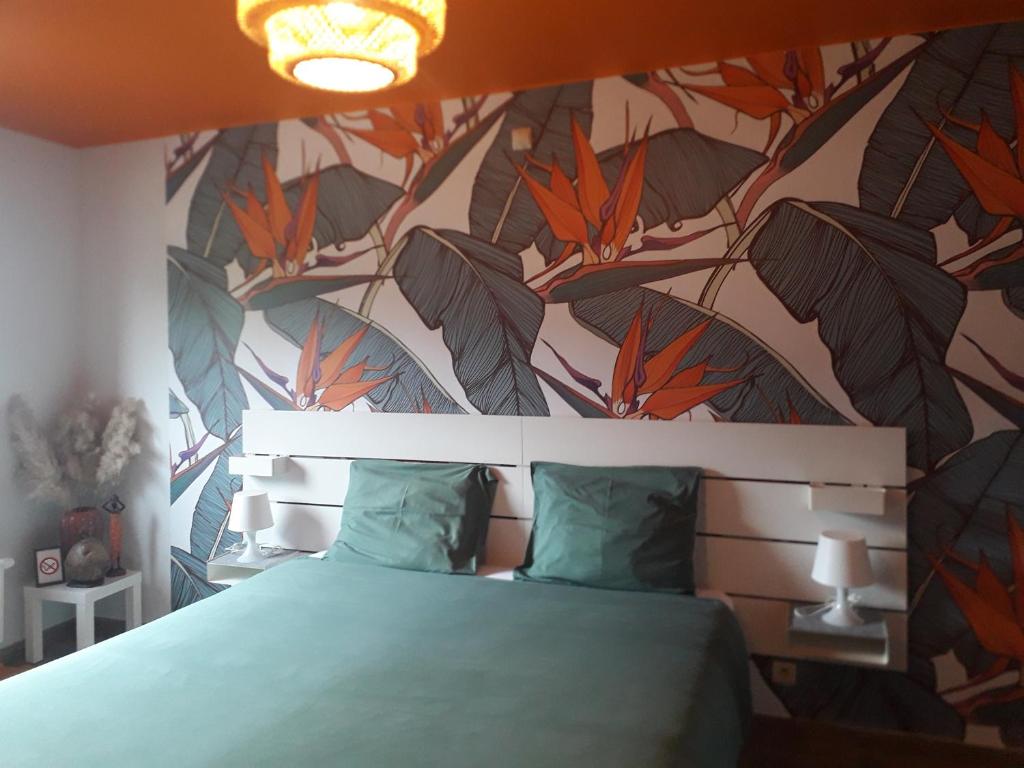 a bedroom with a bed with a floral wallpaper at Veronique schouckens in Binche