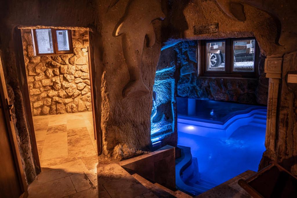 a room with a blue light in a cave at Cappadocia Nar Cave House & Swimming Pool in Nevşehir
