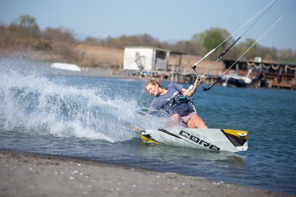 a young man riding a wake board in the water at Allma Kitesurf in Donji Štoj