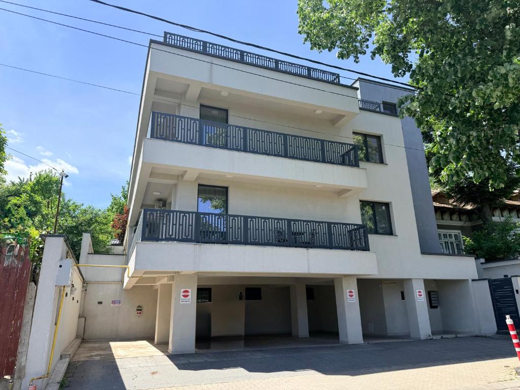 a white building with balconies on top of it at Copou Luxury Suites in Vaslui
