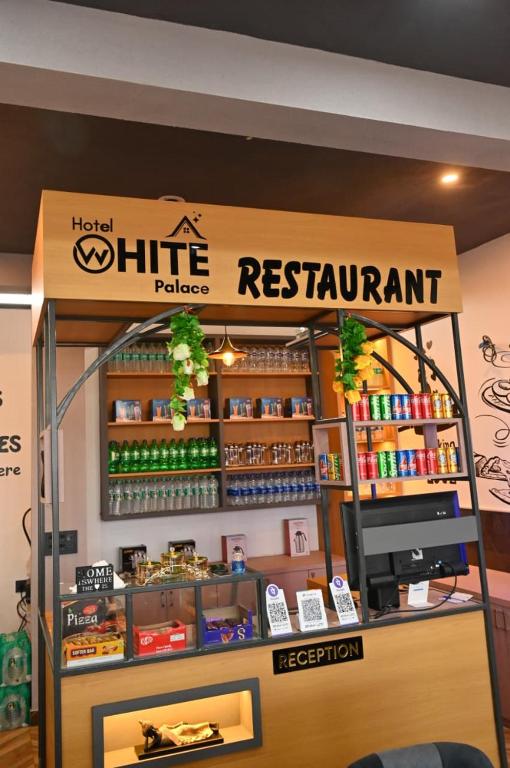 a kiosk for a restaraunt with a registration sign at Hotel White Palace in Nāwa