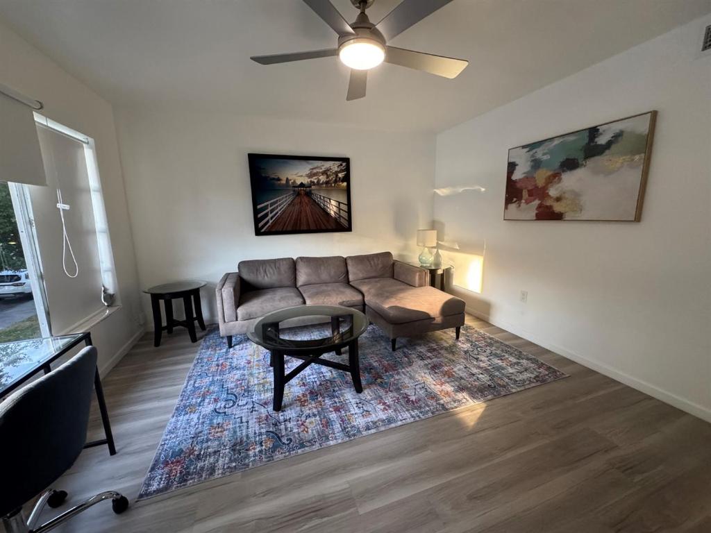 a living room with a couch and a table at Location Lake Eola View 1 Bedroom condo in Orlando
