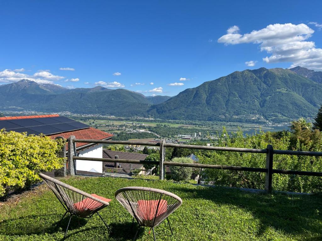 two chairs on a hill with mountains in the background at Casa Kasia by HolAp SA in Contra