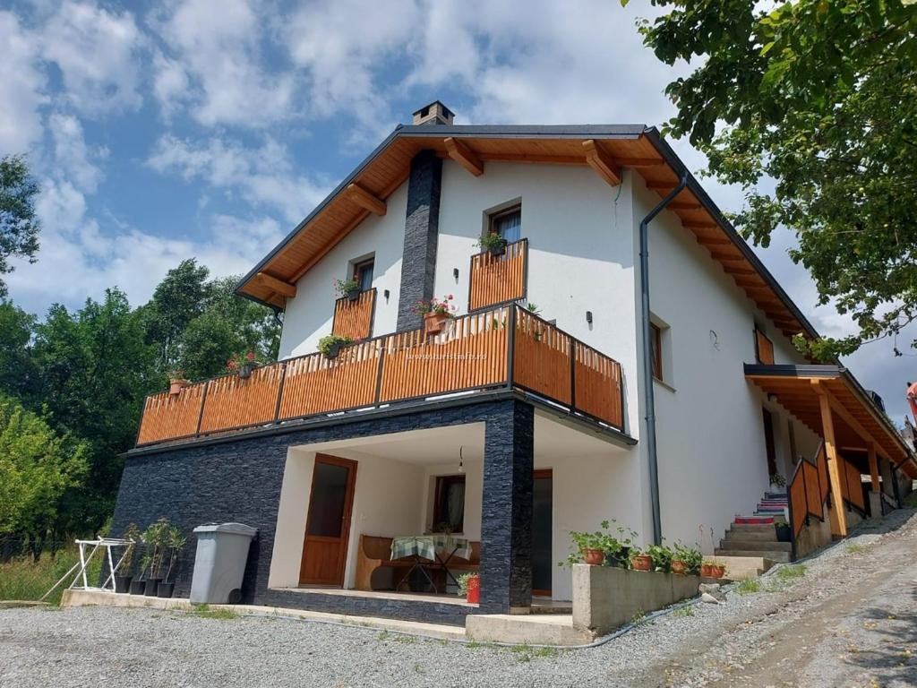a large white house with a balcony at Casa Măriucăi - Ciubar&Mountain View in Borşa