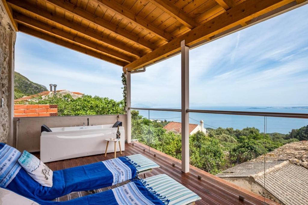 a bathroom with a tub and a view of the ocean at Art House with Seaview & Jacuzzi by Konnect in Spartýlas
