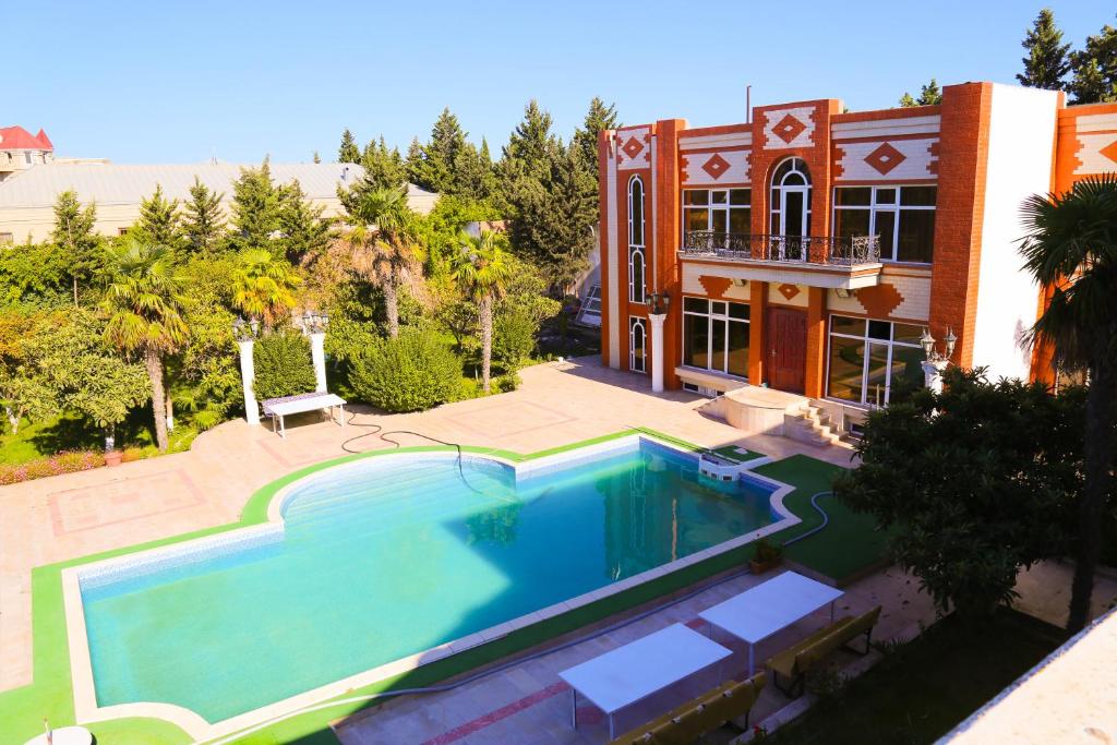 a large swimming pool in front of a house at Premier Villas in Mardakan