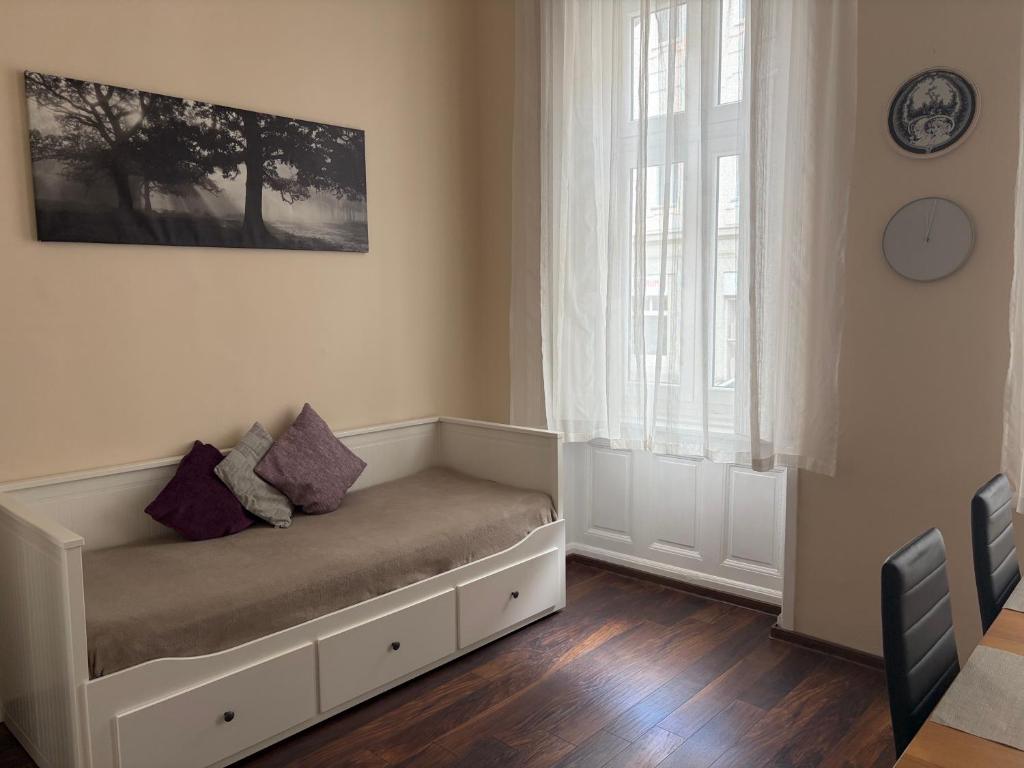 a couch in a room with a window at VM56 in Budapest