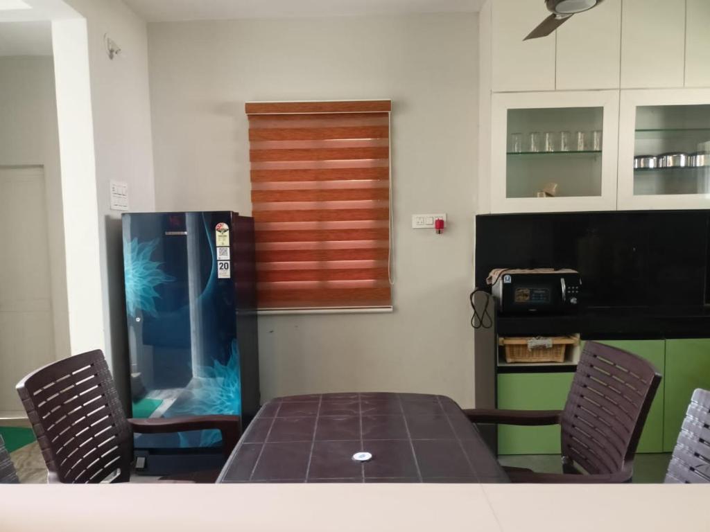 a dining room with a table and two chairs at Aadarsh villa in Daulatābād