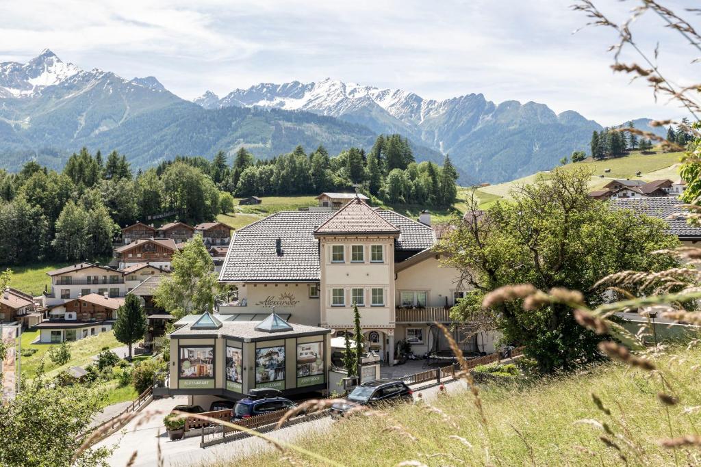 an aerial view of a house with mountains in the background at ALPENAPART Ladis - Premium Family Apartments in Ladis