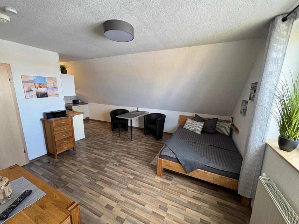 a room with a bed and a table and chairs at Ostseekoje Koje 5 in Süssau