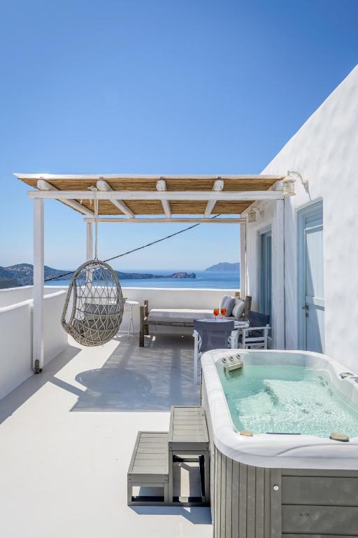 a hot tub on the roof of a house at Plaka Suites in Plaka Milou
