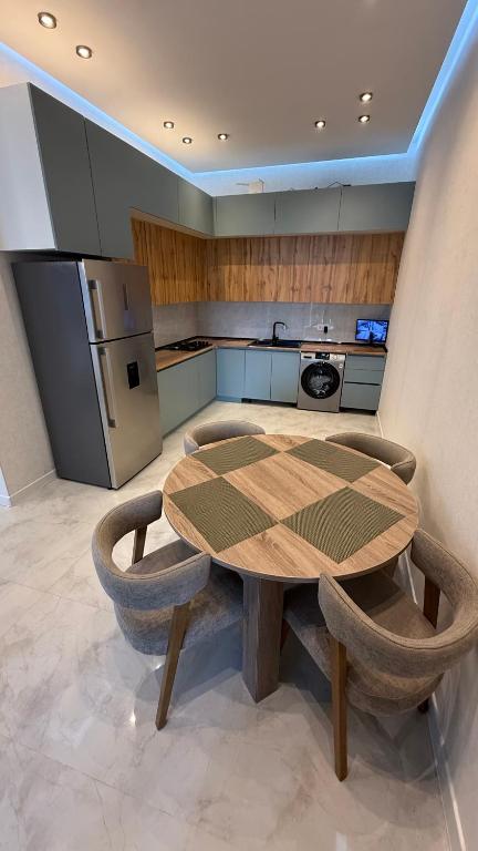 a kitchen with a wooden table and two chairs at ReVaN in Baku