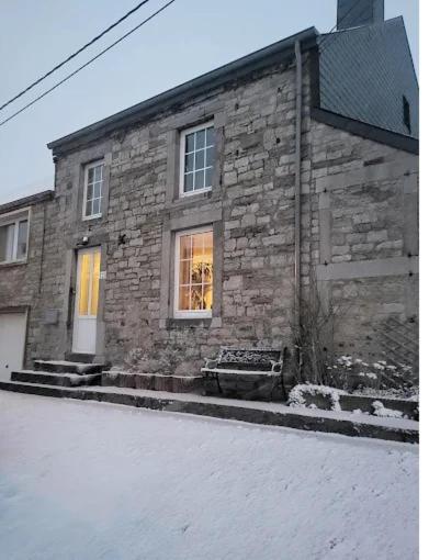 a stone building with a window on a street at Le Cat'saisons in Wellin