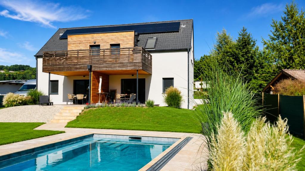 a house with a swimming pool in the yard at Apartment Relax - Stubenbergsee in Stubenberg