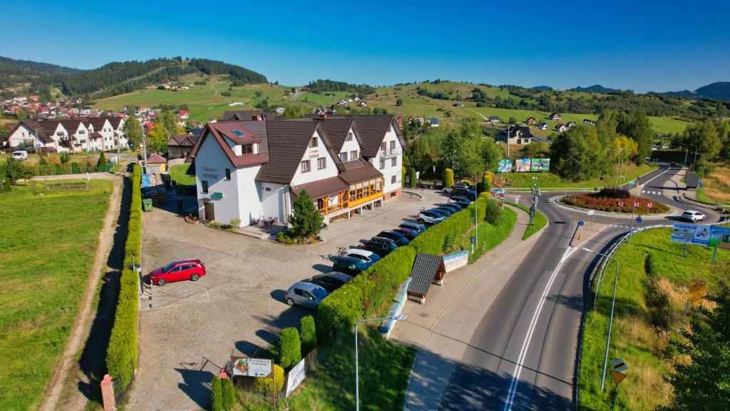 an aerial view of a small town with a road at Gościniec Pieniński in Kluszkowce