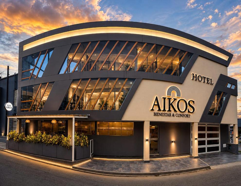 a large building with aolis hospital center at sunset at Hotel Aikos in Yumbo