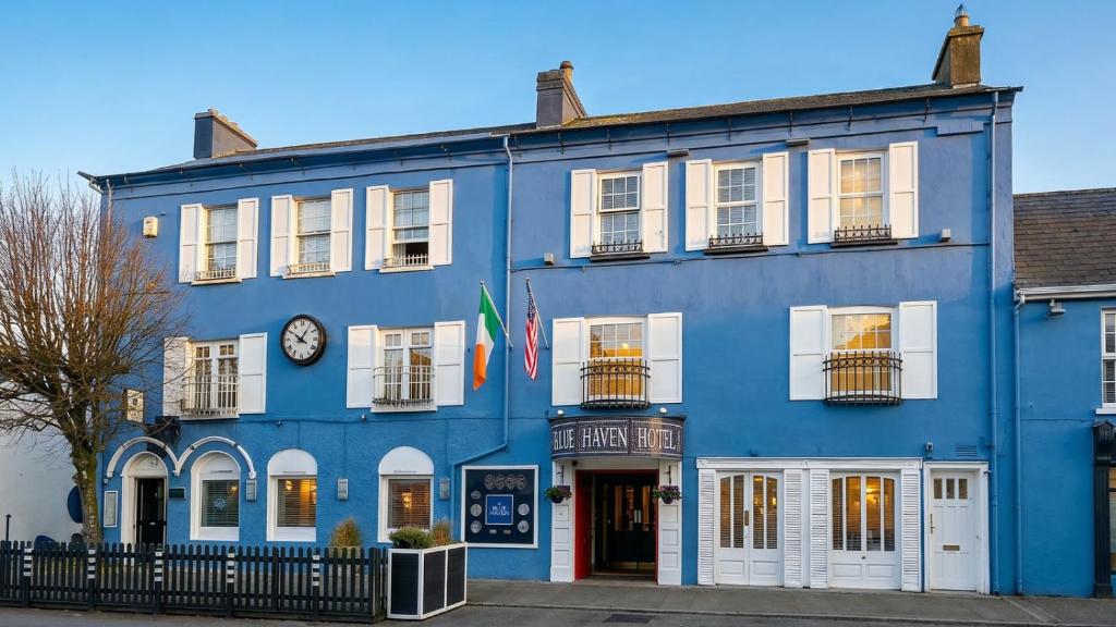 a blue building with a clock on it at The Blue Haven Hotel in Kinsale