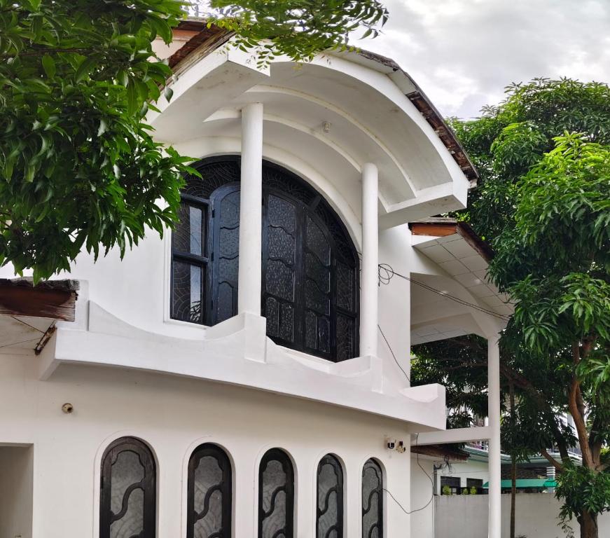 a white building with a window on top of it at Elite moon hotel in Kallady